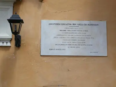 a sign on the side of a building with a lamp at Guest House Trastevere in Rome