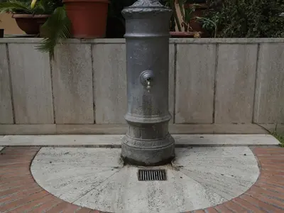 a black fire hydrant sitting on the ground at Guest House Trastevere in Rome