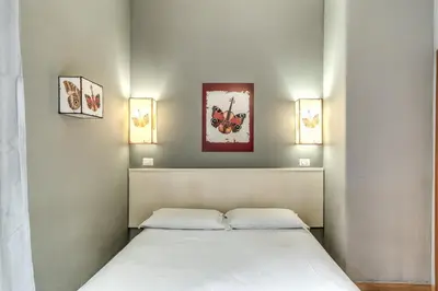 a bedroom with a bed with two pillows at Guest House Trastevere in Rome
