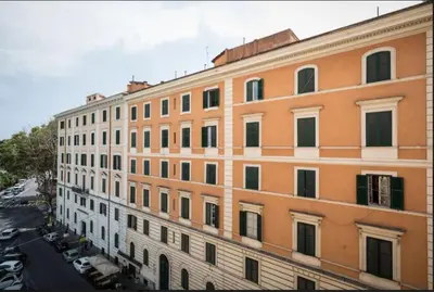 an orange and white building with a lot of windows at Alex Romano in Rome