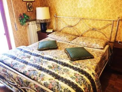 a bed with two pillows on it in a bedroom at Palini's House in Rome