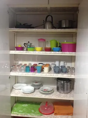 a shelf full of dishes and pots and pans at Palini's House in Rome