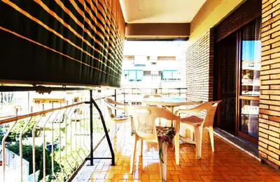 a patio with a table and chairs on a balcony at Palini's House in Rome