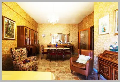a living room with chairs and a table in it at Palini's House in Rome