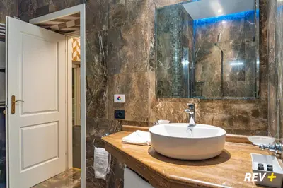 a bathroom with a sink and a mirror at Via Veneto Suites in Rome