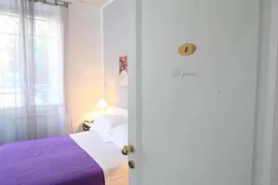 a bedroom with a purple bed and a window at Villa Pirandello in Rome