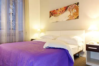 a bedroom with a bed with a purple blanket at Villa Pirandello in Rome