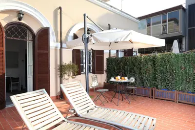 two chairs and an umbrella on a patio at Villa Pirandello in Rome
