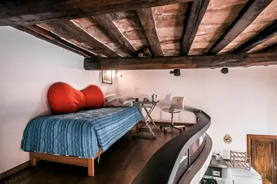 a bedroom with a bed with a red pillow at In Front Of Coliseum in Rome