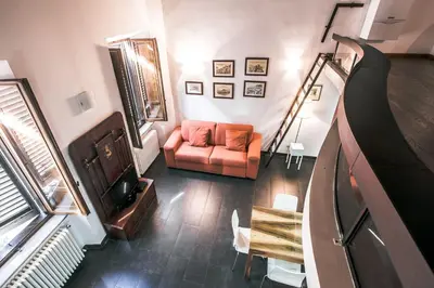 a living room with a couch and a piano at In Front Of Coliseum in Rome