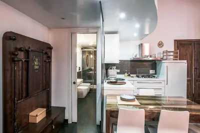 a kitchen with a table and some chairs in it at In Front Of Coliseum in Rome