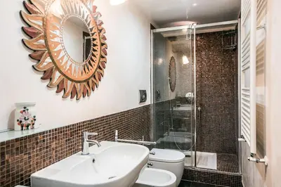 a bathroom with a sink and a mirror on the wall at In Front Of Coliseum in Rome