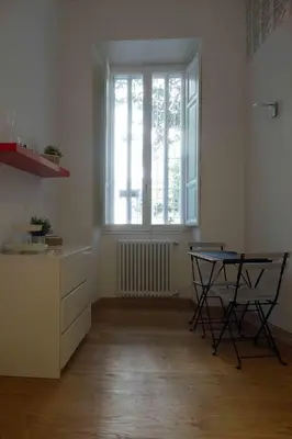 an empty kitchen with a table and a window at Affittacamere ROMA FLAMINIO in Rome