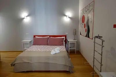 a bedroom with a large bed with two tables at Affittacamere ROMA FLAMINIO in Rome