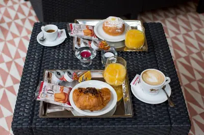 a tray of breakfast foods and coffee on a table at Rome By Suite Vatican in Rome