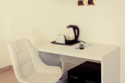 a white desk with a tea kettle on top of it at Rome By Suite Vatican in Rome