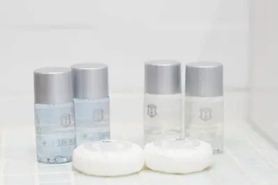 a group of four bottles of moisturizers on a counter at Rome By Suite Vatican in Rome