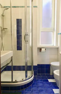 a bathroom with a shower and a sink and a toilet at Panoramic Castle Apt Trastevere in Rome