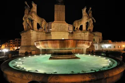 a large fountain in front of a building at night at Veneto Prestige Apartment in Rome