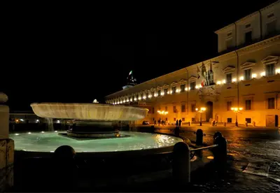a large fountain in front of a building at night at Veneto Prestige Apartment in Rome
