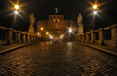 an old building with lights on at night at Veneto Prestige Apartment in Rome