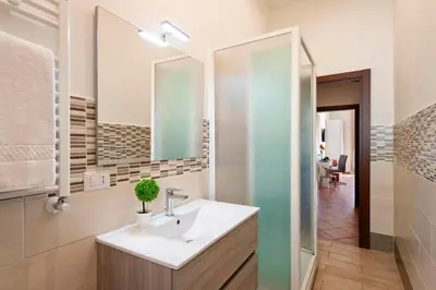 a bathroom with a sink and a mirror at Veneto Prestige Apartment in Rome