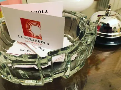 a glass basket with a bottle of wine on a table at La Girandola Bed & Breakfast in Rome