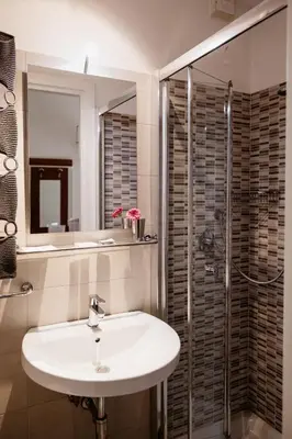 a bathroom with a sink and a glass shower at La Girandola Bed & Breakfast in Rome