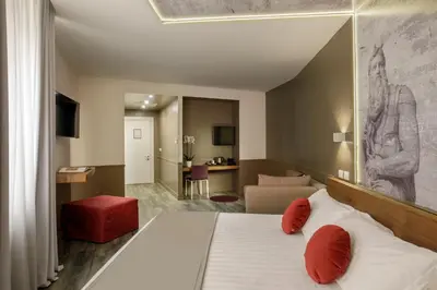 a bedroom with a bed and a living room at Hotel Regno in Rome