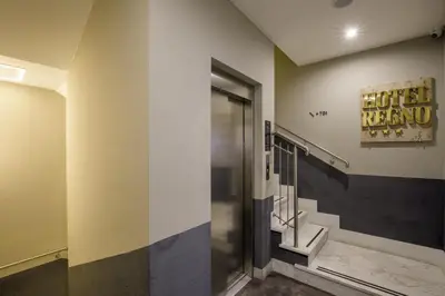 a hotel room hallway with a hotel renew sign on the wall at Hotel Regno in Rome