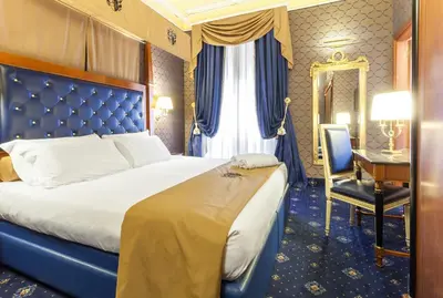 a hotel room with a bed and a desk at Hotel Manfredi Suite In Rome in Rome