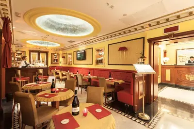 a restaurant with tables and chairs and a bar at Hotel Manfredi Suite In Rome in Rome