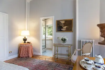 a room with a bed and a table with a lamp at Suite Oriani in Rome
