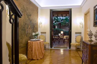 a hallway with a table and a dining room at Suite Oriani in Rome
