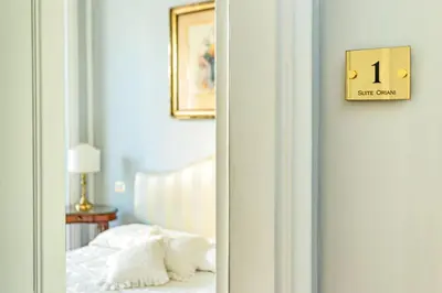 a bedroom with a bed and a clock on the wall at Suite Oriani in Rome