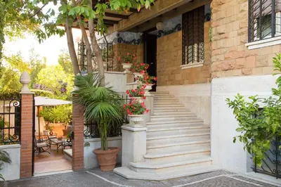 a stairway with potted plants on the side of a building at Suite Oriani in Rome