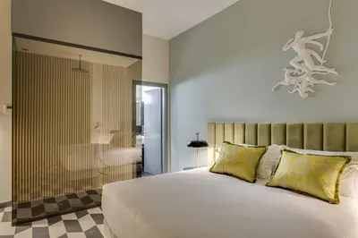 a bedroom with a large bed and a bath tub at Otivm Hotel in Rome