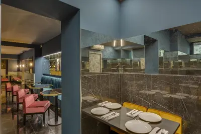 a restaurant with tables and chairs and a bar at Otivm Hotel in Rome