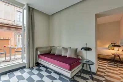 a bed in a room with a window at Otivm Hotel in Rome