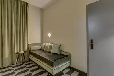 a room with a couch with a window and a table at Otivm Hotel in Rome