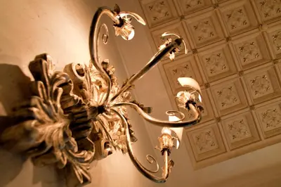 a gold chandelier hanging from a ceiling at Hotel Aventino in Rome