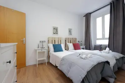a bedroom with two beds and a window at Monti Central Apartment in Rome
