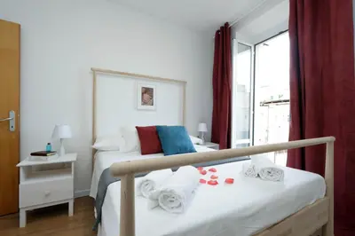 a bedroom with a bed with towels and a window at Monti Central Apartment in Rome