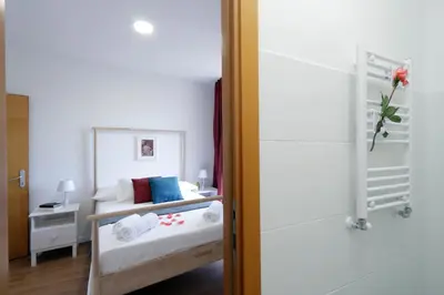 a small bedroom with a bed with a mirror at Monti Central Apartment in Rome