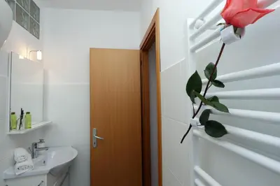 a bathroom with a toilet and a flower on the door at Monti Central Apartment in Rome