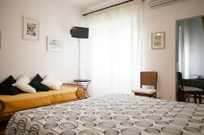 a bedroom with a bed and a window with a television at La Fabbrica di San Pietro B&B in Rome