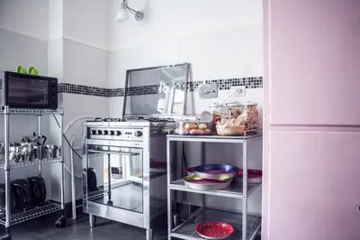 a kitchen with a stove and a refrigerator at La Fabbrica di San Pietro B&B in Rome