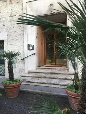 a front door of a building with potted plants at La Fabbrica di San Pietro B&B in Rome
