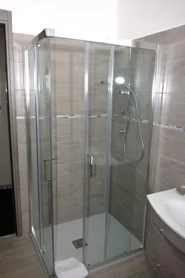 a shower with a glass door in a bathroom at In vacanza da Sara in Rome