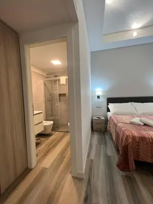 a bedroom with a bed and a bathroom at ARTPA Rome Apartments in Rome